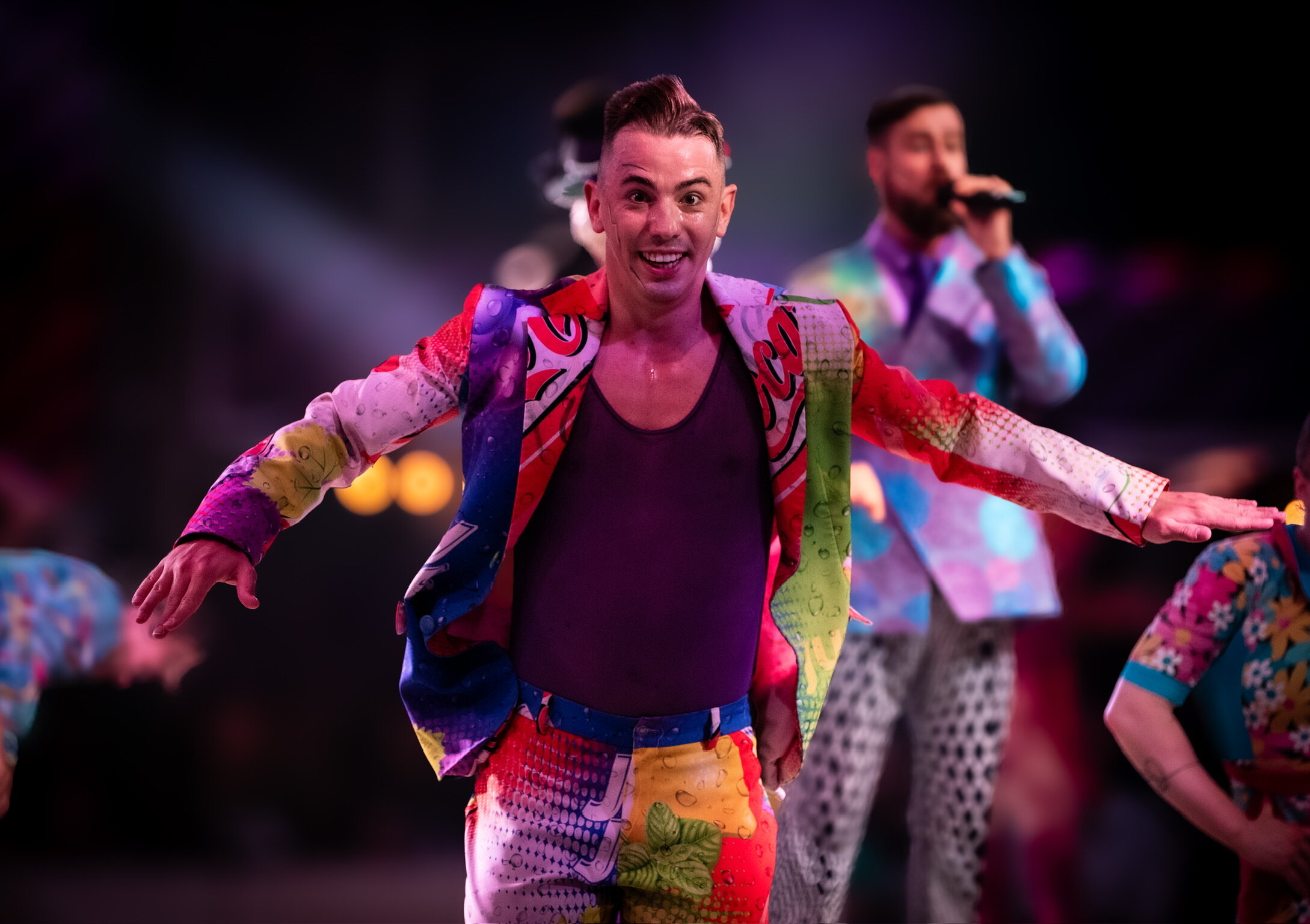 Colorful stage performer in motion