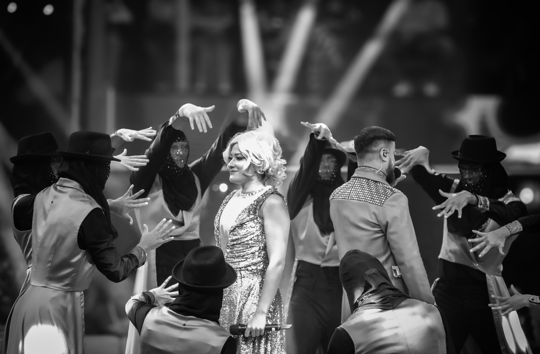 Theatrical ensemble performing in black and white