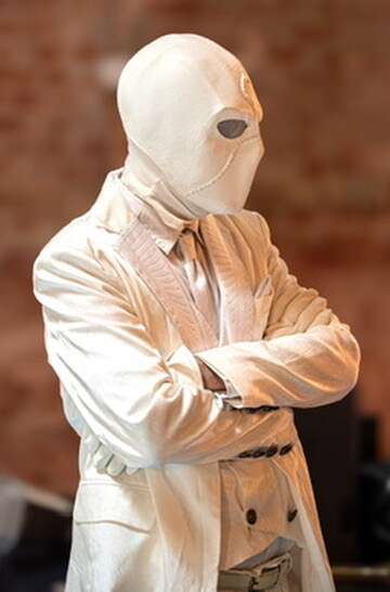 Masked performer dressed in white