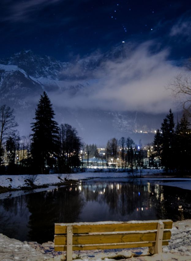 Snowy city waterfront at night