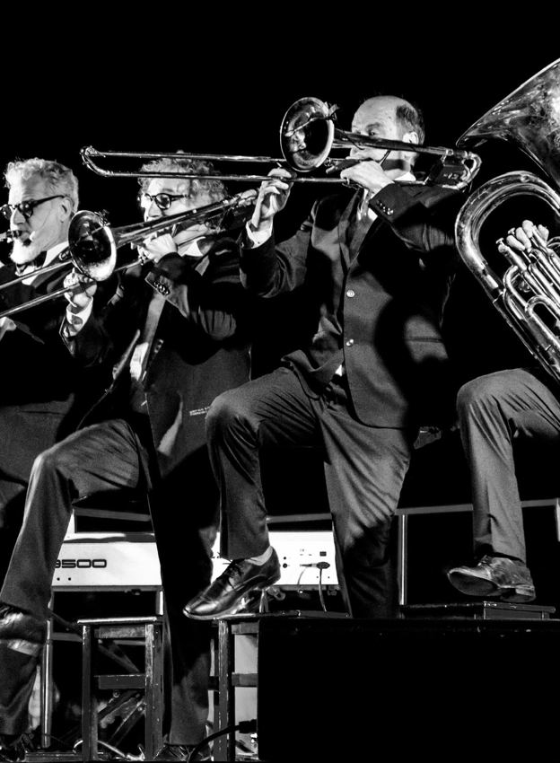 Musicians performing in black and white