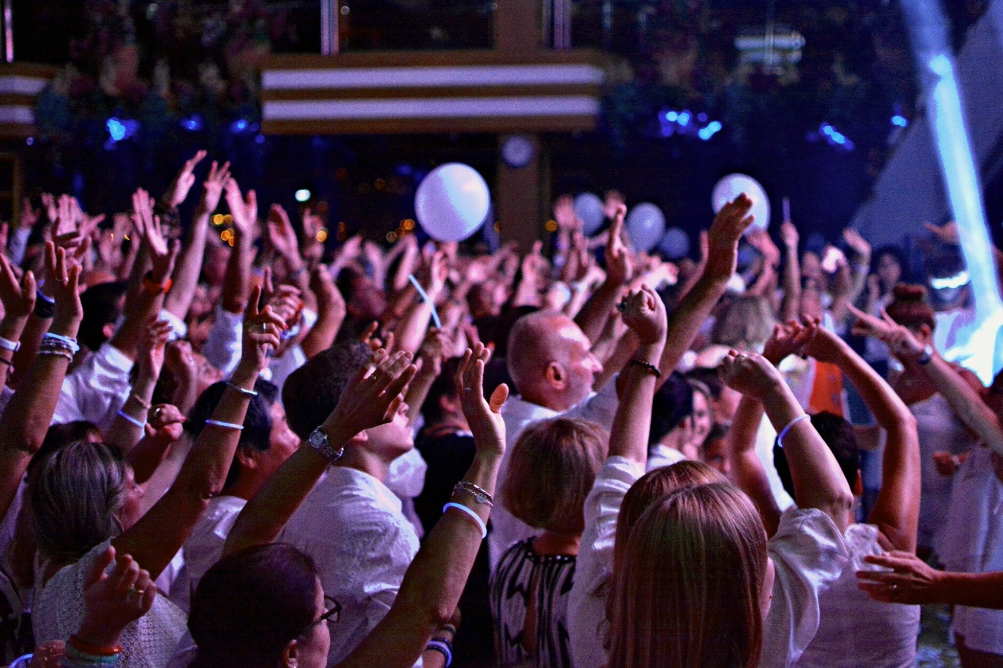 Concert audience reaching toward the stage